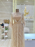 Load image into Gallery viewer, A flowing, sleeveless maxi dress in a soft, shimmering fabric, perfect for a summer evening