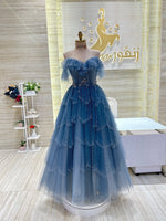 Load image into Gallery viewer, A shimmering, silver, sleeveless gown with a flowing skirt, perfect for a formal event.exclamation