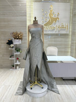 Load image into Gallery viewer, A shimmering, silver, sleeveless gown with a flowing skirt, perfect for a formal event.exclamation