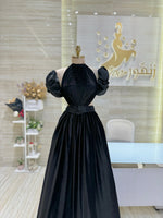 Load image into Gallery viewer, A classic black, sleeveless cocktail dress with a simple silhouette, ideal for a formal occasion.