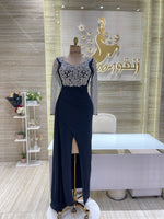 Load image into Gallery viewer, A shimmering, silver, sleeveless gown with a flowing skirt, perfect for a formal event.exclamation