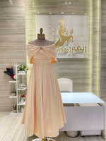 Load image into Gallery viewer, A stunning gold, off-the-shoulder maxi dress with a flowing skirt, perfect for a summer evening party.