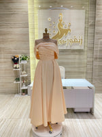 Load image into Gallery viewer, A stunning gold, off-the-shoulder maxi dress with a flowing skirt, perfect for a summer evening party.