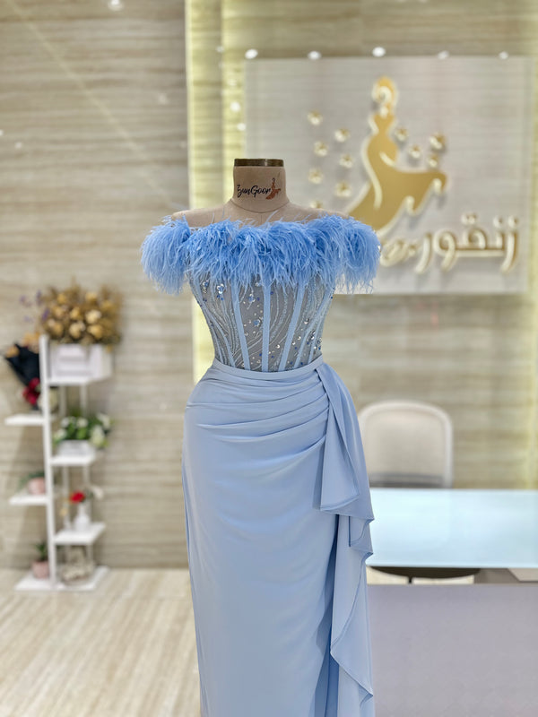 A soft pink, off-the-shoulder dress with delicate lace details, perfect for an engagement party.