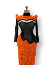 A soft peach, single-cloche dress with elegant sleeves, perfect for a family gathering.