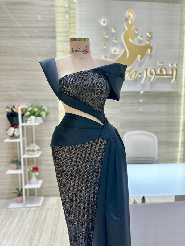 A classic black, sleeveless cocktail dress with a simple silhouette, ideal for a formal occasion.