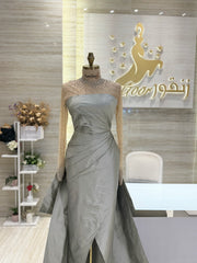 A soft peach, single-cloche dress with elegant sleeves, perfect for a family gathering.