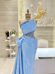 A soft pink, off-the-shoulder dress with delicate lace details, perfect for an engagement party.
