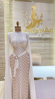 A soft peach, single-cloche dress with elegant sleeves, perfect for a family gathering.