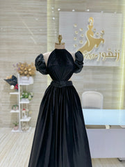 A classic black, sleeveless cocktail dress with a simple silhouette, ideal for a formal occasion.
