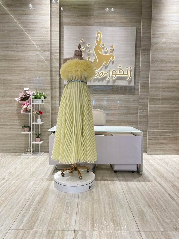 A stunning gold, off-the-shoulder maxi dress with a flowing skirt, perfect for a summer evening party.
