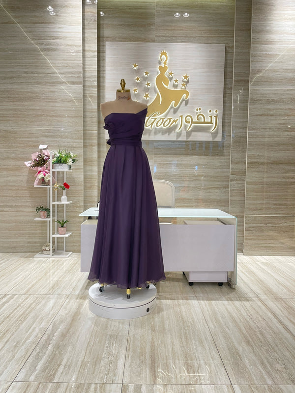 A captivating mauve, double-cloche dress with a flattering waistline, perfect for a special occasion.exclamation